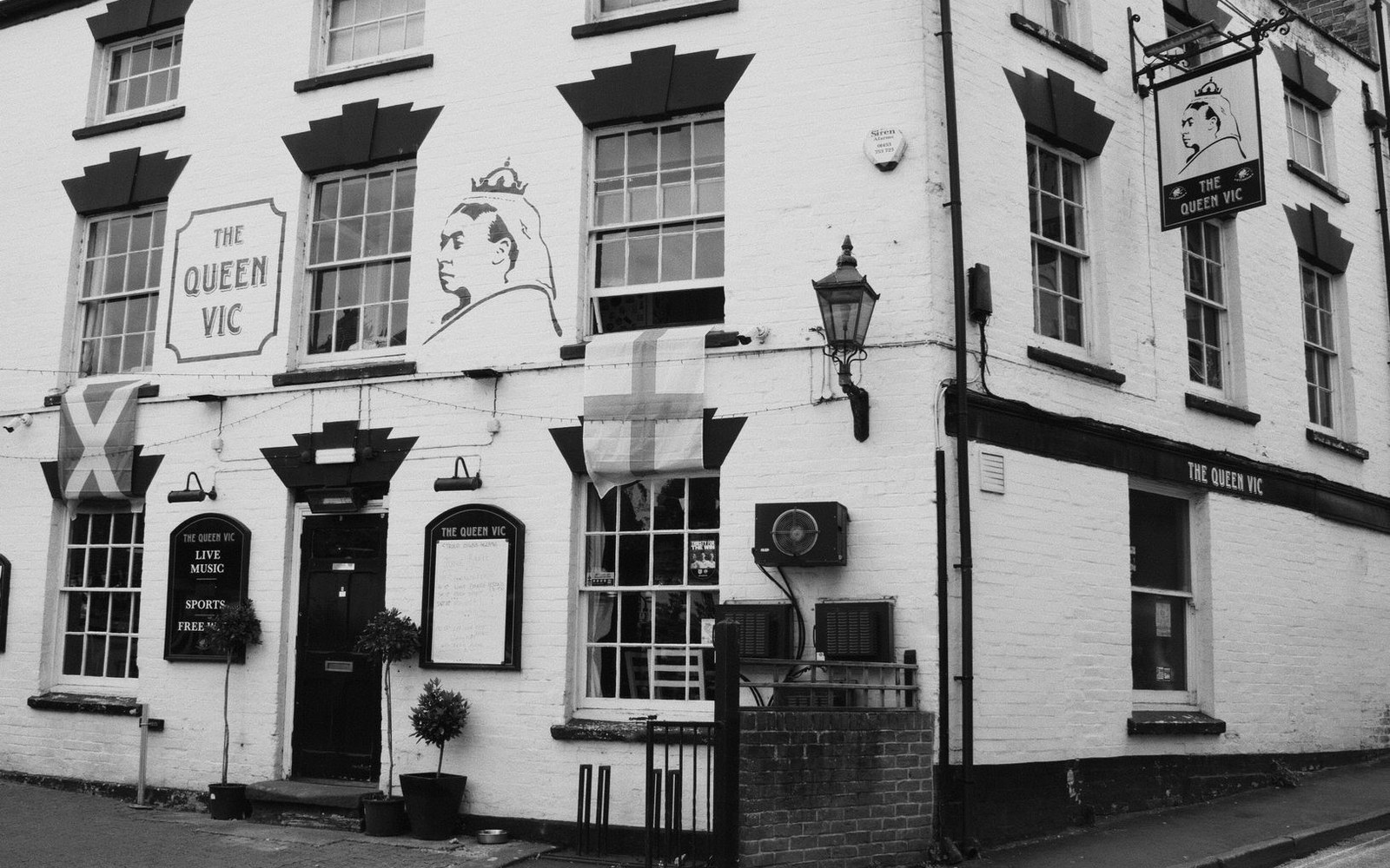 The Queen Vic pub exterior with a painted portrait of Queen Victoria on its facade