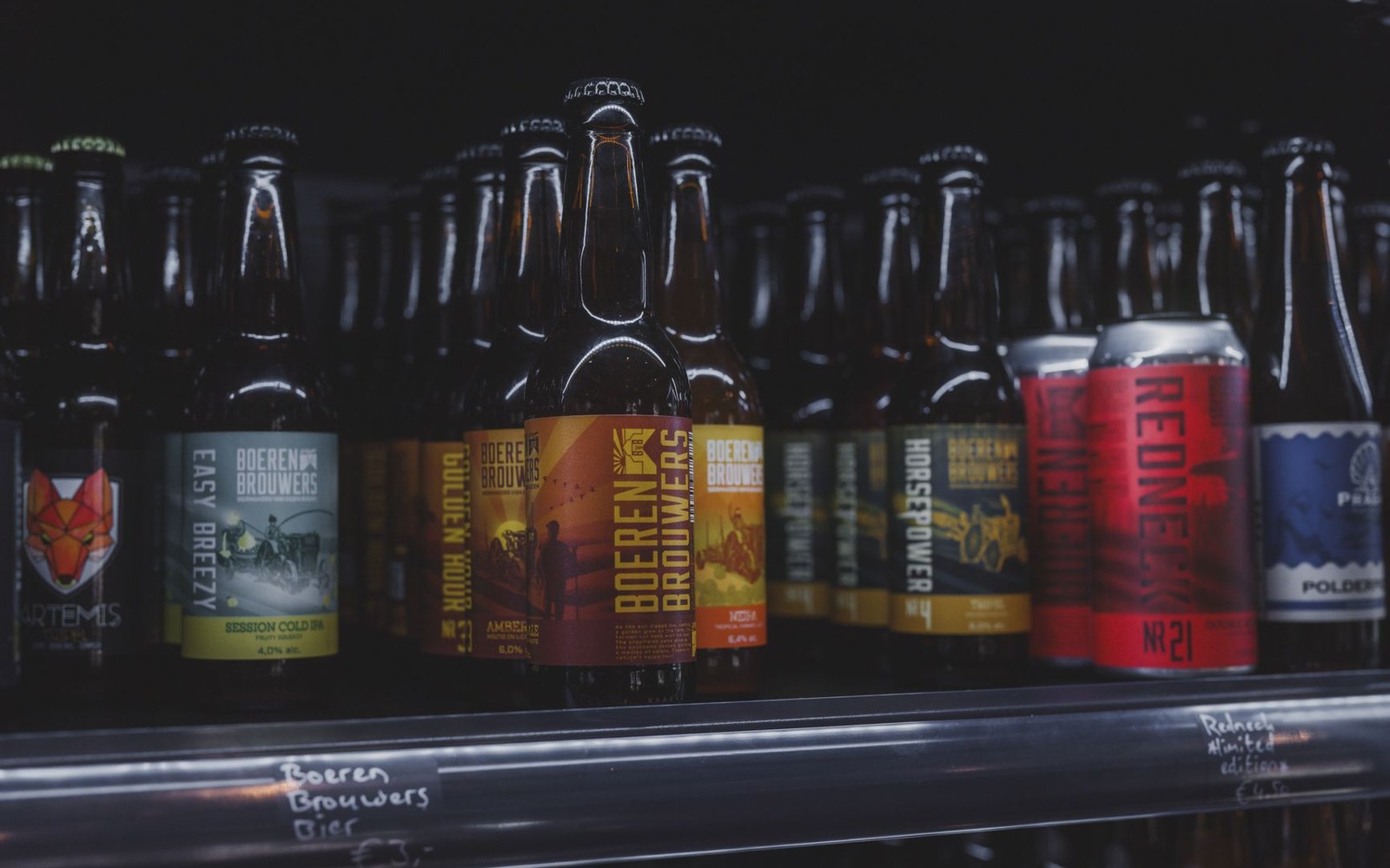 Athletic Brewing and Guinness 0.0 cans lined up on a retail shelf